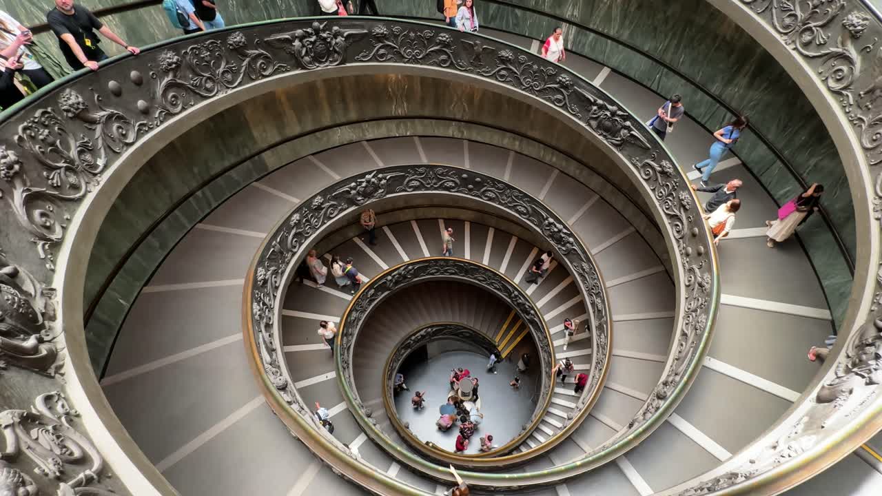 People navigating the famous spiral staircase in the Vatican Museums