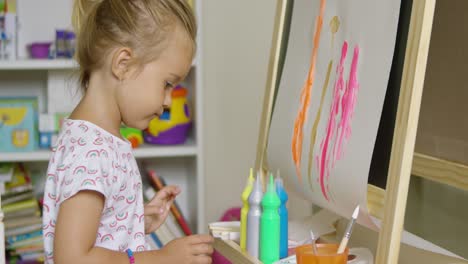 Cute-little-blond-girl-painting-with-watercolors