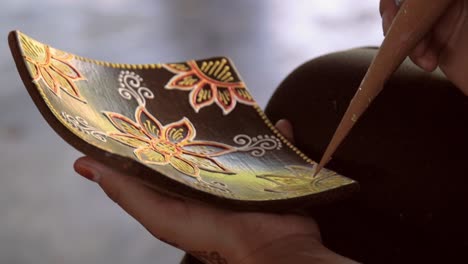 close-up of hands decorating a dish