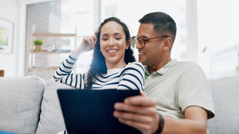 Smile,-tablet-and-conversation-with-couple-on-sofa