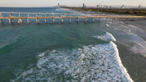 scenic view of the gold coast seaway sand pumping jetty at the spit, main beach in queensland, australia