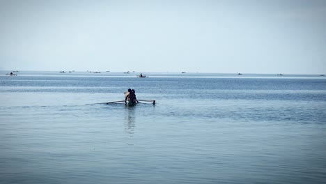 anglers and small-fry fishermen on tiny rowboats go about finding their daily catch to bring to market at a fishing town in the visayas region of the philippines.