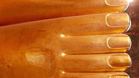 close-up of the reclining buddha's golden feet