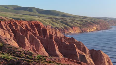 aerial pan of sellicks beach red cliffs with golden hour light near adelaide, south australia