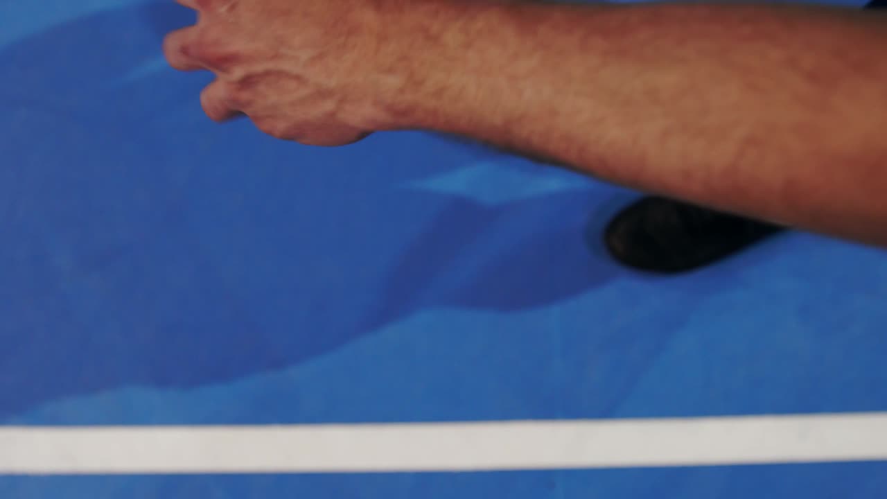 Tennis player holding the ball and getting ready to serve. Close-up feet tennis player preparing to serve. Knocking the ball on the court and hitting the racket