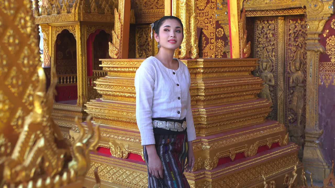 Woman in Traditional Thai Clothing at a Temple