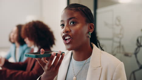 businesswoman speaking into a phone during a meeting