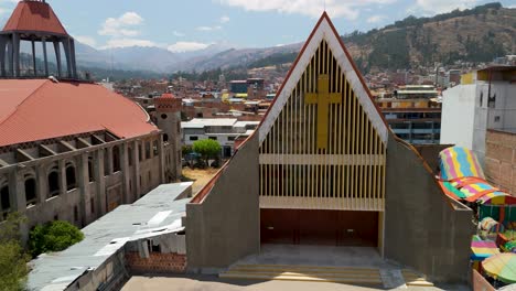 sagrario de san sebastián cathedral in huaraz, peru, showcasing its unique modern architecture against the backdrop of the city and the andes mountains - a dynamic aerial parallax shot