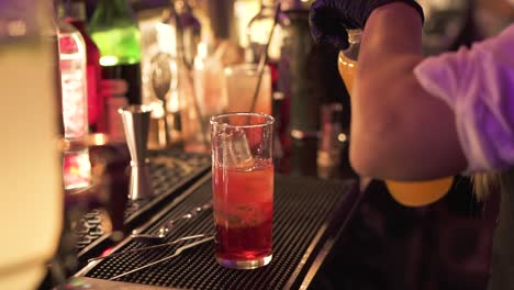 Woman-works-in-bar-serving-cocktails-during-party