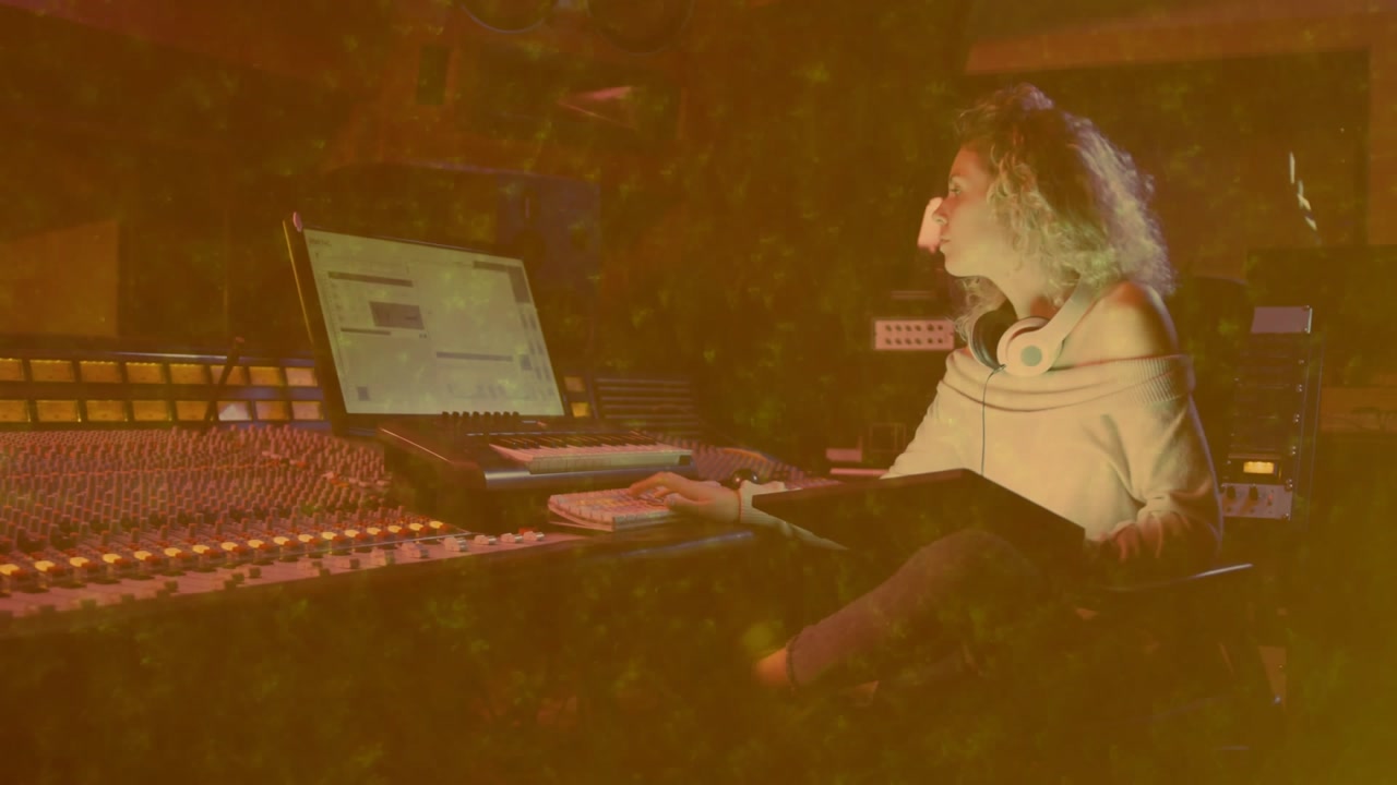 Woman producing at mixing console starting checking notebook, adjusting hair, moving faders for mix