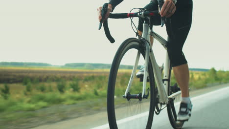 female triathlete riding sport bike on road