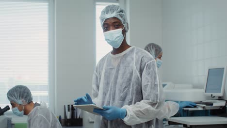 scientists in protective gear working in a laboratory