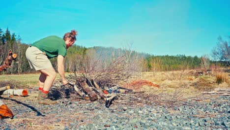 a man is carefully burning wood to char it for preservation - static shot