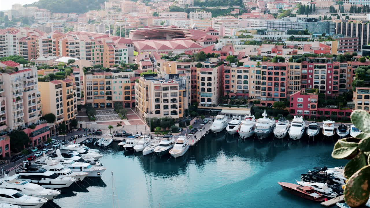 View of boats docked in the Port de Fontvieille with the skyline of Monaco on the background
