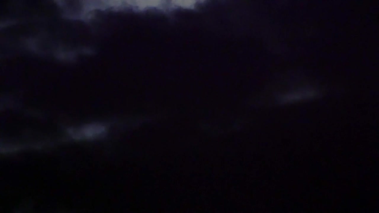 The moon being covered by clouds.