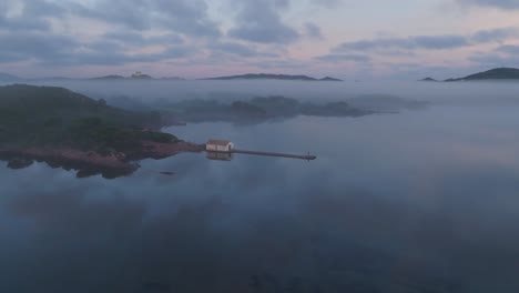 Pink-golden-dusk-hour-skyline-drone-panoramic-island-bay-water-landscape,-Mediterranean-green-cliff-shore