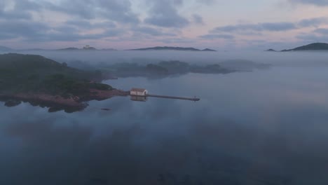 pink golden dusk hour skyline drone panoramic island bay water landscape, mediterranean green cliff shore