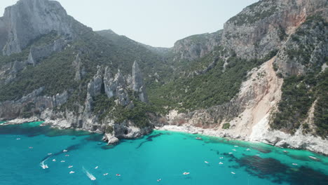 Aerial-drone-video-of-tropical-paradise-turquoise-beach-in-the-mediterranean,-Cala-Goloritz?