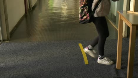 children walking back to school after covid pandemic, keep distance, floor marks