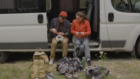 heterosexual couple sitting in a van