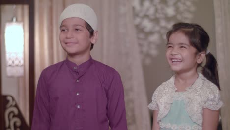 muslim children smiling, happy to receive gifts from parents on eid holidays