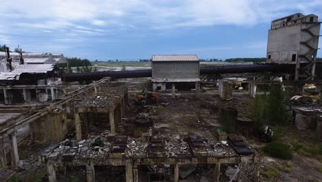 ghostly atmosphere of an abandoned and destroyed factory, drone shot