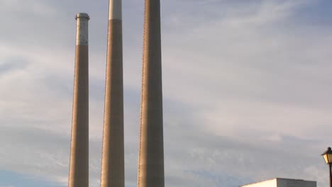 a slow tilt up to the towers of a power plant