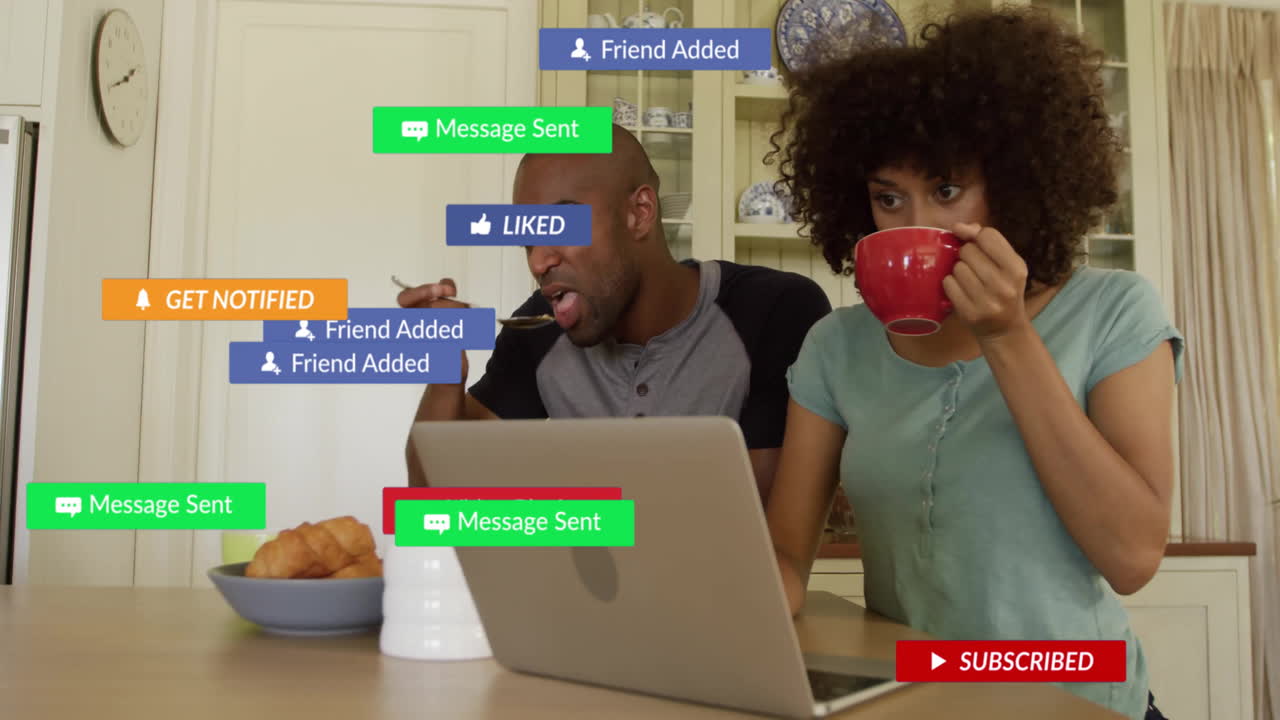 couple sharing breakfast using laptop for social media marketing, showing notification icons