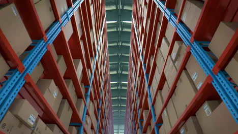 inventory control, order fulfillment or space optimization, cardboard boxes on metal shelves rack full of carton in large industrial warehouse distribution center storage show efficiency automation