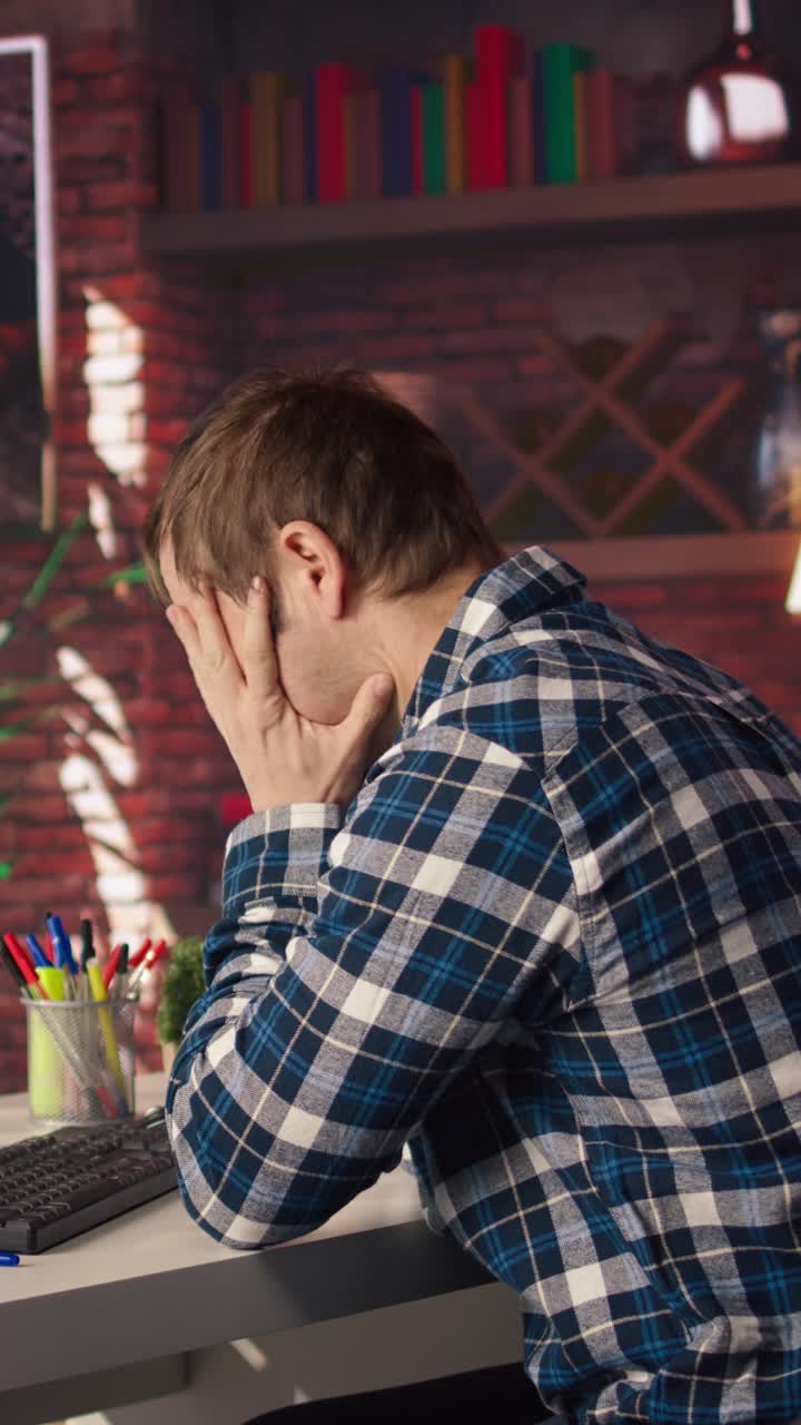 Vertical video Programmer in home office having deadline, stressed to finish debugging software