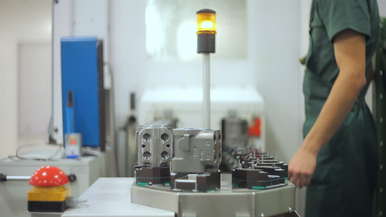 Factory worker taking industrial unit from conveyor. Quality inspection