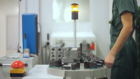 factory worker taking industrial unit from conveyor. quality inspection