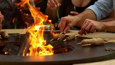 man hands preparing meat snacks on grill on backyard. male chef grilling meat