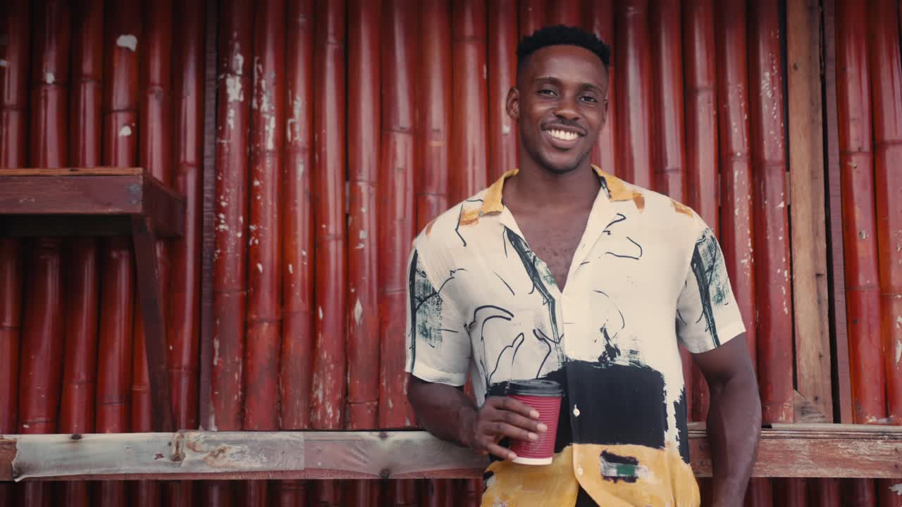Man with Coffee by Red Bamboo Wall