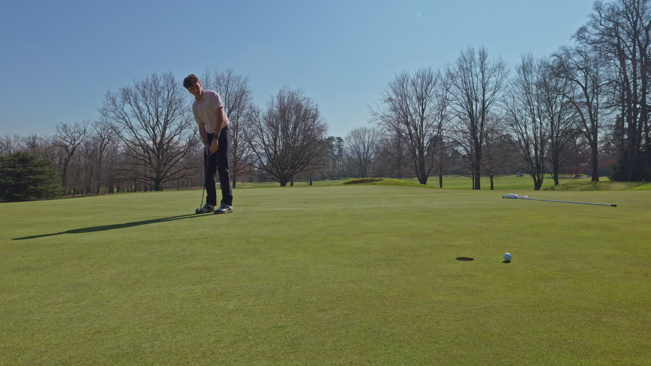 Young golfer playing on a sunny spring day in Switzerland, showcasing precise chipping, putting, bunker, and approach shots. Perfect for sports, lifestyle, and outdoor themes.