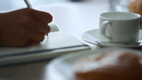 Woman-hand-writing-on-notepad