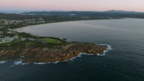 aerial: drone shot of tathra headland early morning before the sun rises, south coast nsw, australia