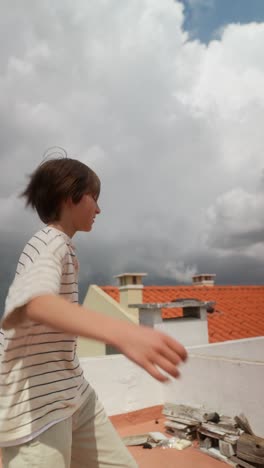 child dancing and walking on a rooftop