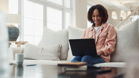 mujer feliz trabajando en una computadora portátil en casa