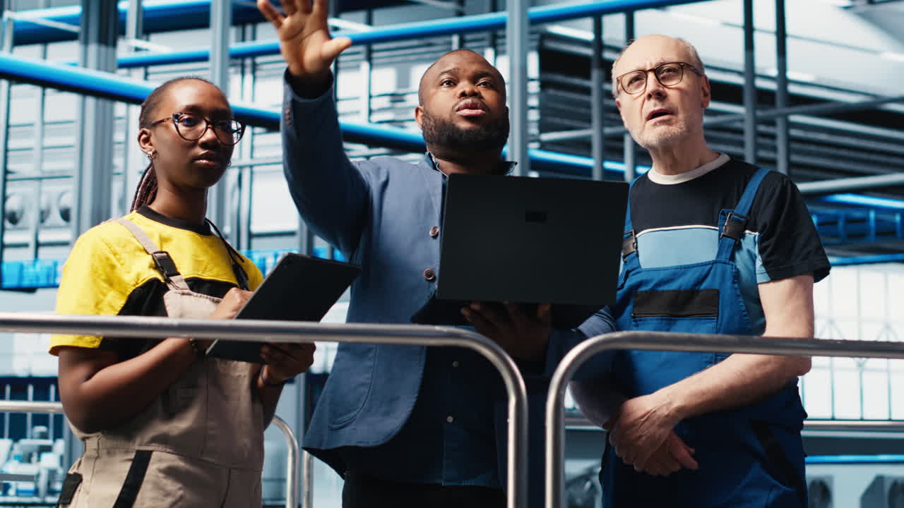 Smart factory manager discussing with employees