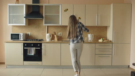 woman singing and dancing in a kitchen