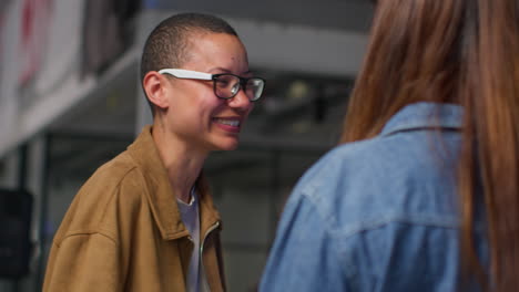 two women smiling and talking to each other