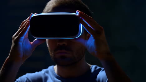man wearing a virtual reality headset with glowing blue lights