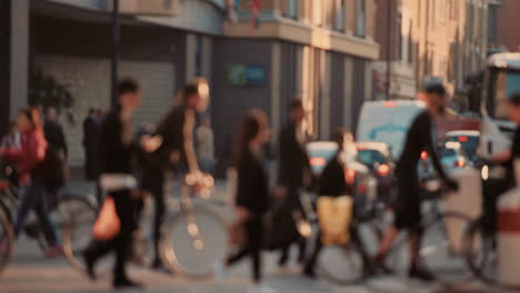 anonymous crowd of people walking cycling bicycles commuters london city street slow motion