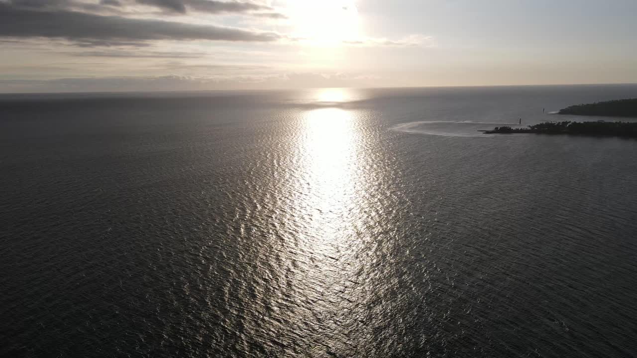Aerial View of Golden Sun Reflection on Calm Ocean Water at Sunset