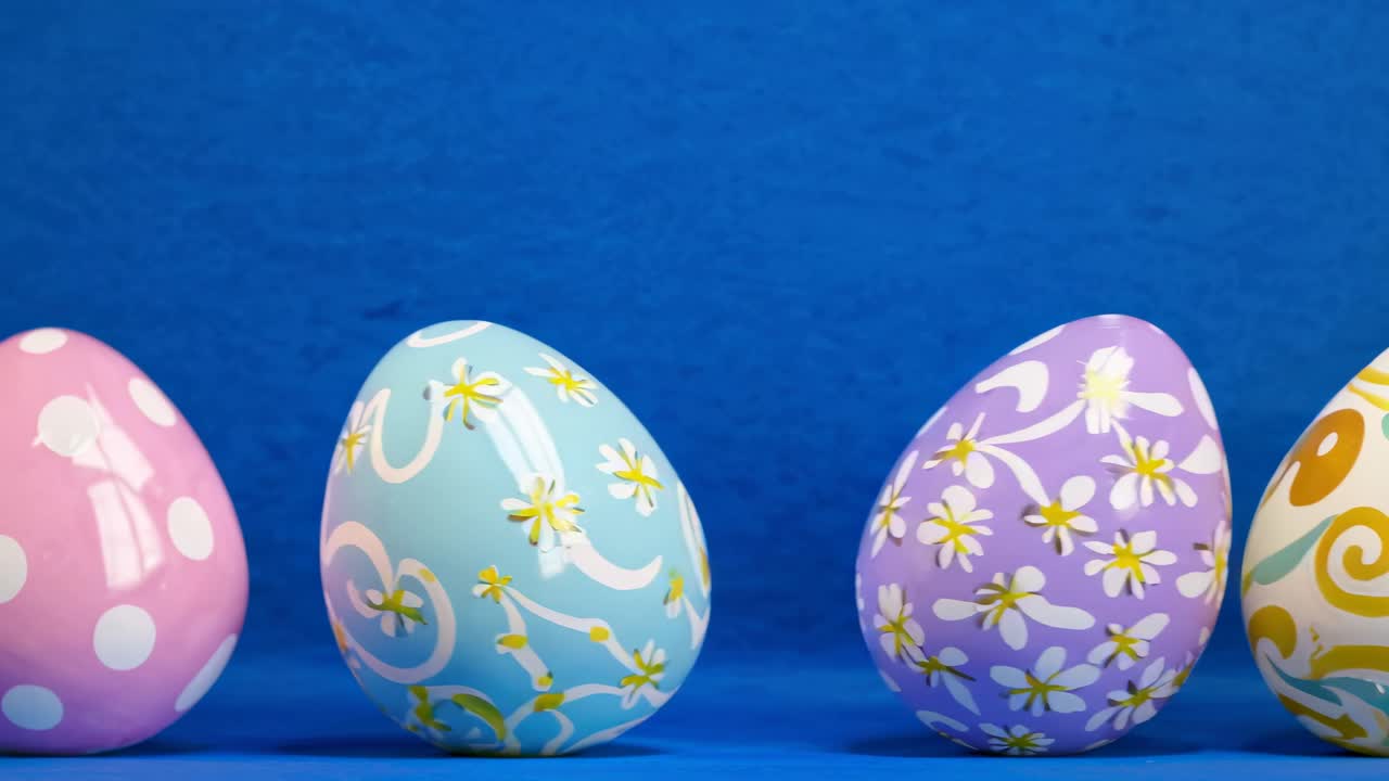 Colorful Easter eggs with floral and abstract patterns on a blue background