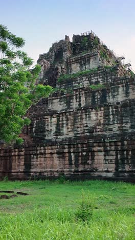 vertical reveal of ancient pyramid temple of prasat tom at koh ker, cambodia.
