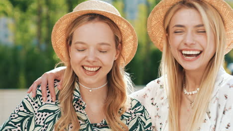 two happy friends laughing outdoors