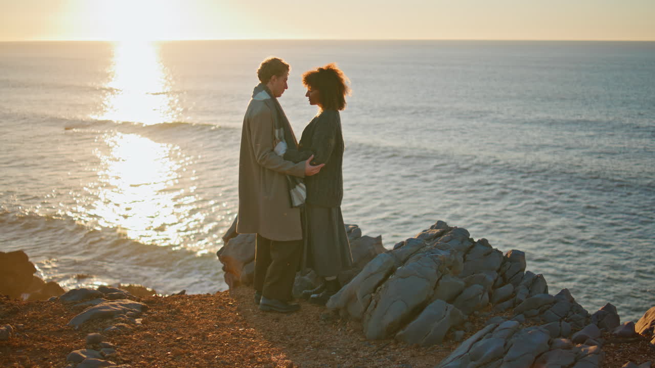 Tender newlyweds embracing sundown beach at nature. Lovers hugging at sunset