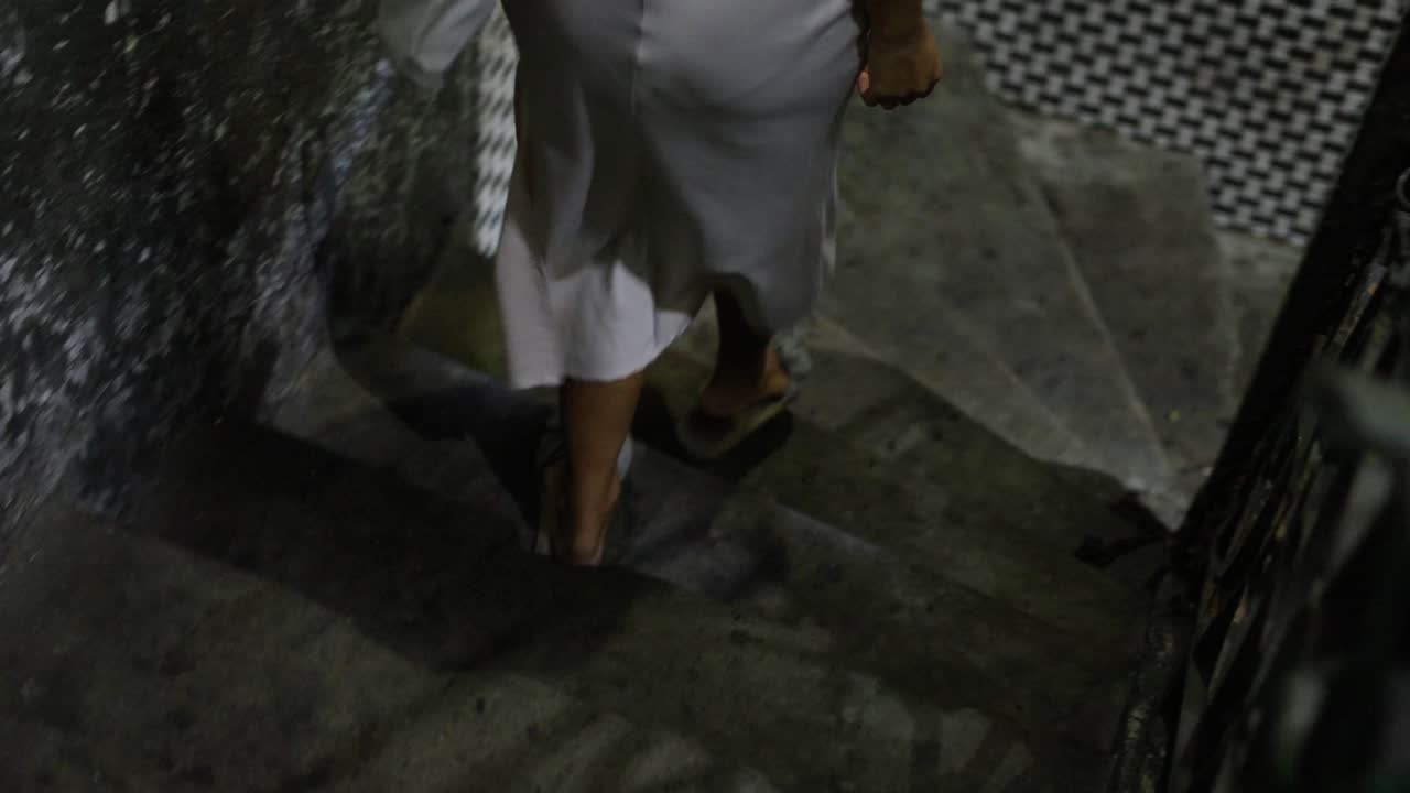 Woman Walking Down Stairs